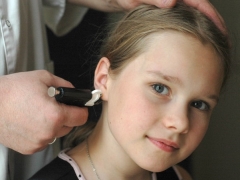 Ear piercing children with a pistol