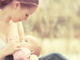 Mom feeds the baby with breast milk