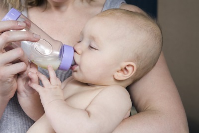 Il bambino sta bevendo dalla bottiglia