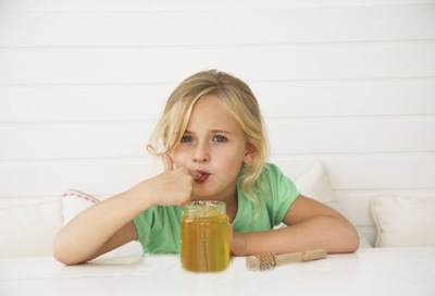 Baby eating honey