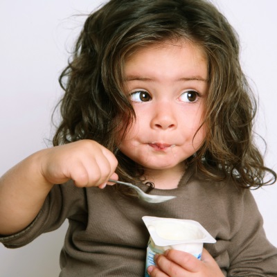 Chica comiendo yogurt prebiótico