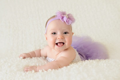 Baby at 3 months smiling - girl in dress