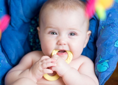 Baby with a teether for teeth