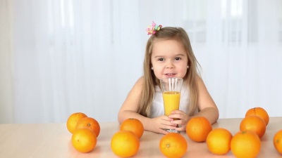 Girl with oranges and orange juice