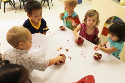 The child eats pomegranate with bones