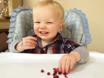 Baby eats pomegranate