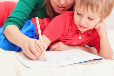 A child learns to write letters and numbers.