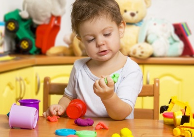 Child with a dough for modeling