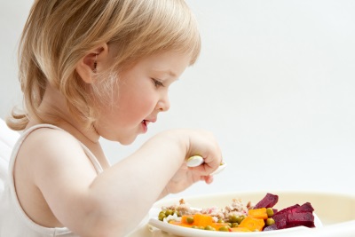 Baby eating beetroot dish