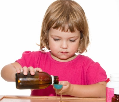 Cough syrup girl pours a measuring cup